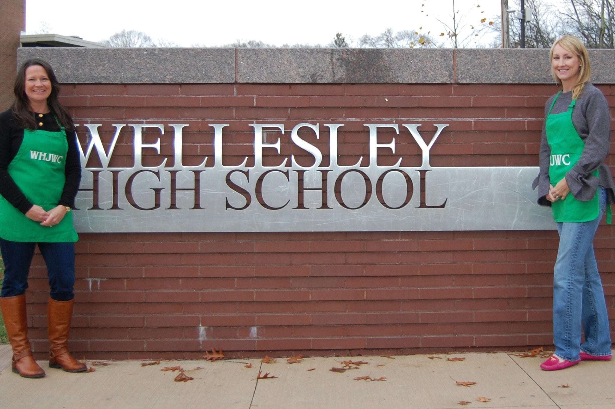 Wellesley Marketplace Chairs Tara Lawrence and Julia Woodward strike a pose outside the Marketplace's new location at Wellesley High School.